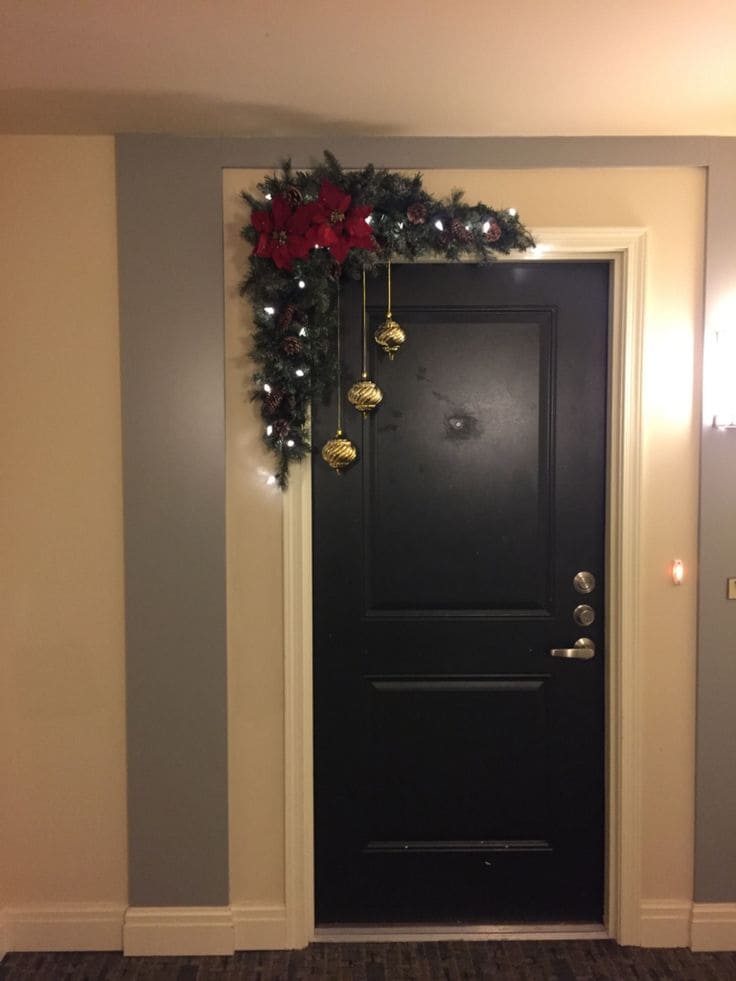 Elegant Doorway with Festive Poinsettias and Golden Baubles