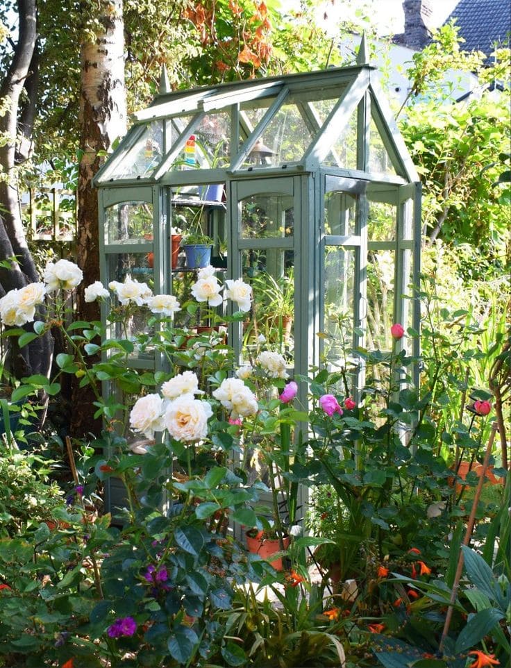 Glass Mini Greenhouse with Floral Surroundings