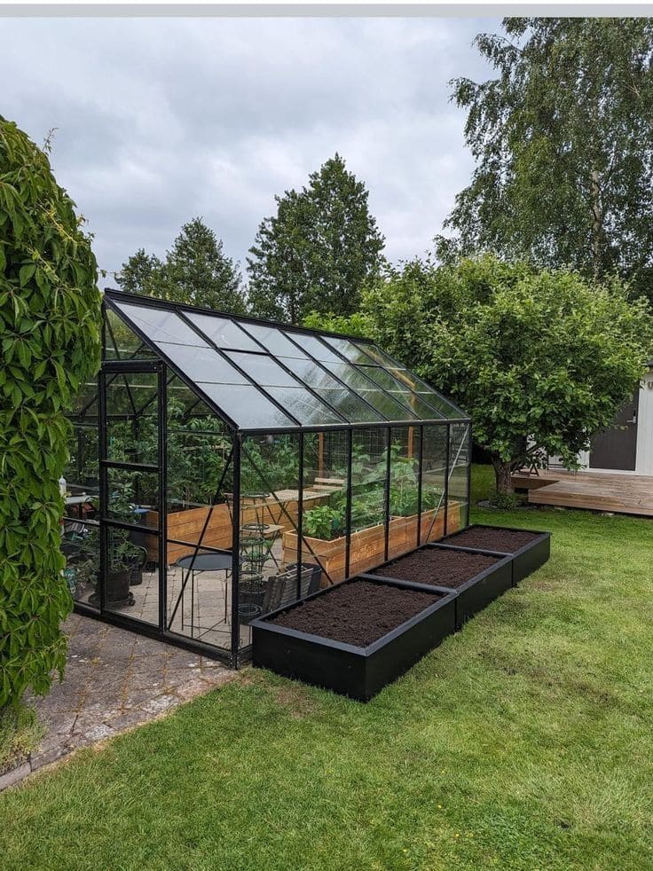 Modern Glass Greenhouse with Black Frame Beds