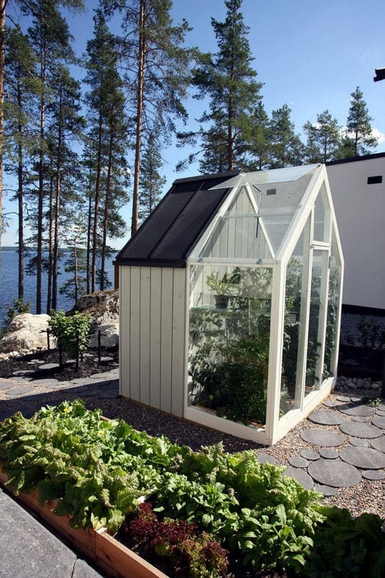 Modern Lakeside Mini-Greenhouse with Glass and Steel