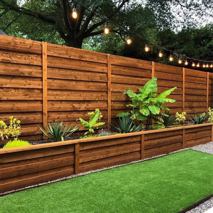 Sleek Wooden Fence with Lush Planter Bed