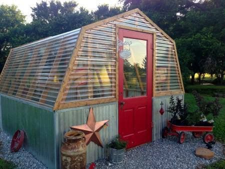 Vibrant Red Door Greenhouse with Metal Panels